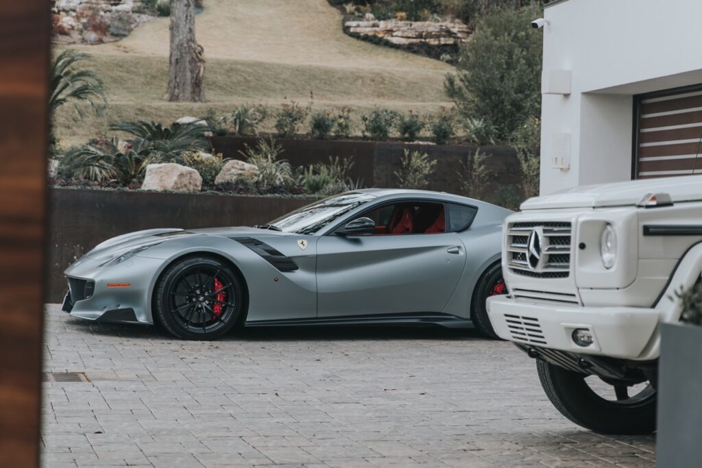 silver coupe parked near house